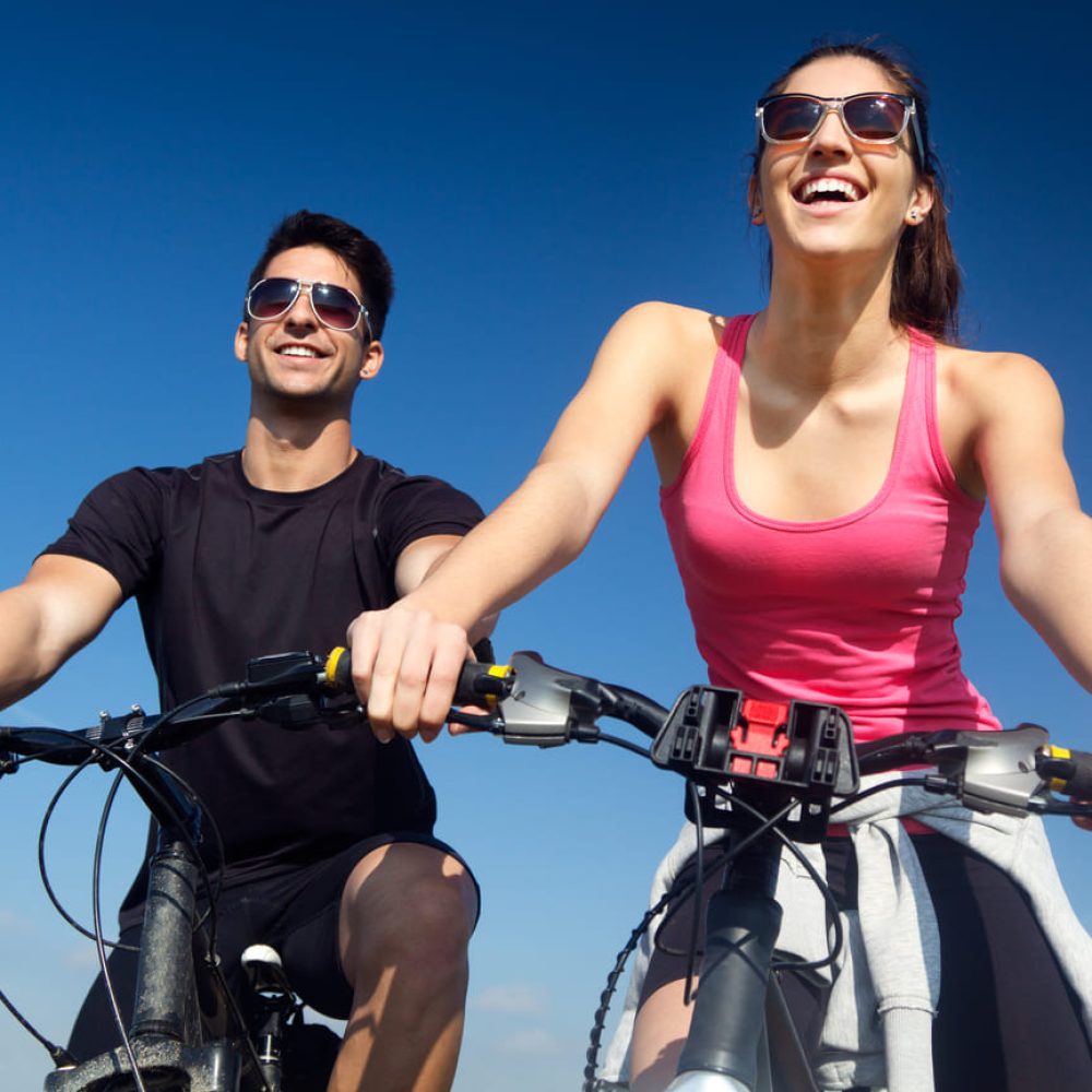 happy-young-couple-on-bike-ride-in-the-countryside (1) (1)